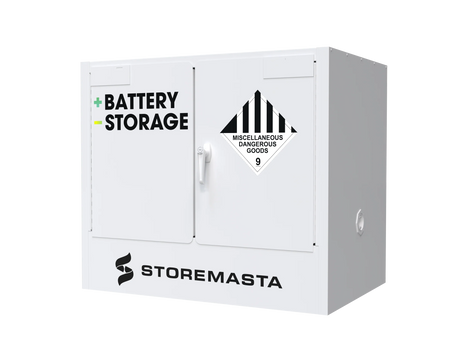 A white battery storage cabinet with the label 'BATTERY STORAGE' on the front and a 'Hazardous Substances' warning sign. The brand 'STOREMASTA' is visible at the bottom.