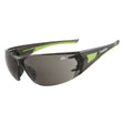 A pair of protective eyewear with a polycarbonate lens, green and black frame, and adjustable nose bridge.
