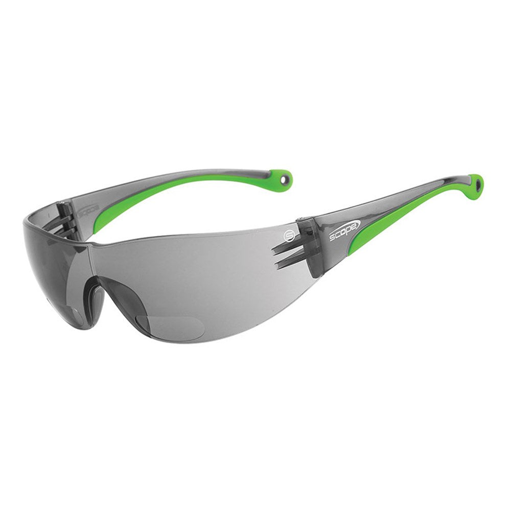 A pair of protective eyewear with smoke lenses and green accents on the frame and temples.