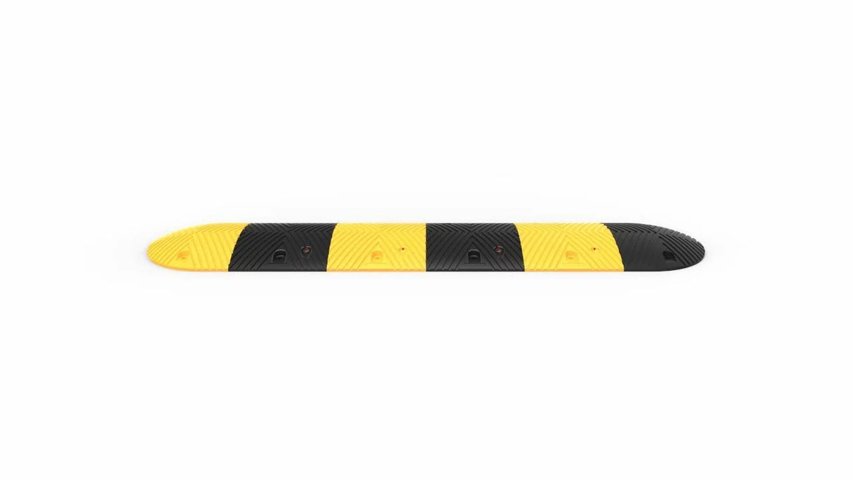 Yellow and black striped traffic bump on a white background