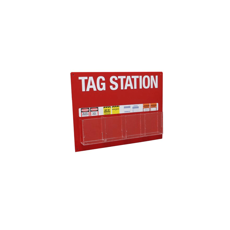 A red tag station with the text 'TAG STATION' printed in white on the top surface, with a yellow warning sign on the left side and a red caution sign on the right side.