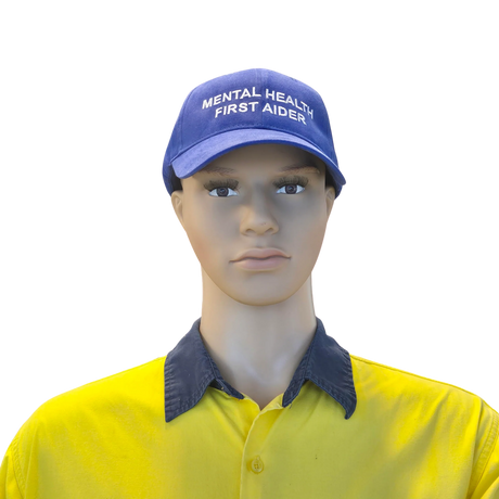 Mannequin head wearing a blue cap with 'Mental Health First Aider' text and a yellow shirt.